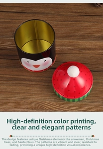 Detail view of penguin Christmas candy tin with red polka dot hat lid on wood