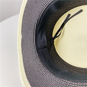 Detail of adjustable inner sweatband and dual-color straw weave of the boater hat