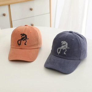 Close-up of kids' baseball cap with embroidered dinosaur skeleton on solid cotton fabric