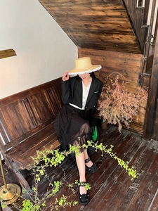 Straw hat with white lace trim and pearl accents styled with a vintage black outfit
