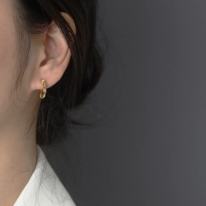 Irregular twisted gold metal hoop earrings for women with a minimalist aesthetic design