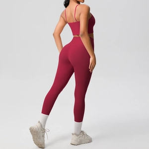 Rear view of deep red yoga set featuring thin strap sports bra and high waist leggings