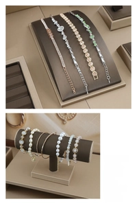 Detailed view of jewelry display stands with elegant bracelets and pearl necklaces