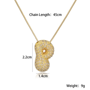 Detail view of a gold peanut pendant with micro-inlaid diamonds and chain dimensions