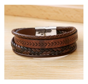 Close-up of brown multilayer braided leather bracelet with vintage metal magnetic clasp