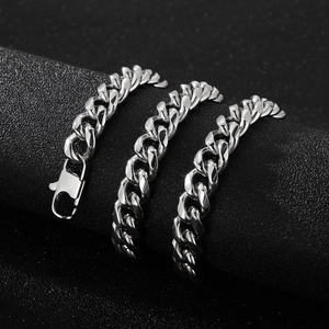 Detailed view of silver Cuban link chain wrapped around a black cylindrical jewelry stand