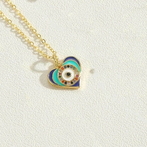 Detail of heart evil eye pendant with multicolor enamel and sparkling zircon inlay