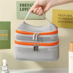 Dual-layer breathable grey mesh makeup bag with orange zippers and top carry handle