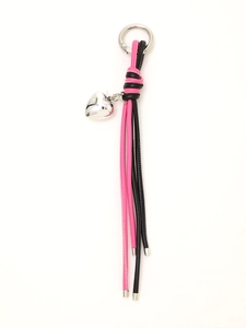 Detail of pink and black woven leather keychain with a silver heart pendant on white background