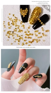 Detailed close-up of 3D gold pyramid nail studs with independent packaging for manicure