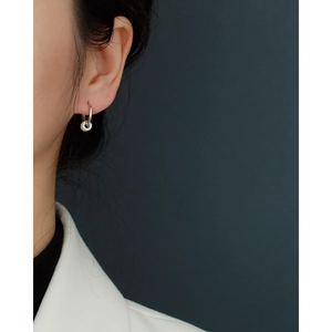Close-up of S925 sterling silver hoop earrings with sparkling crystal charms on a model