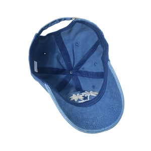 Inside view of blue washed cotton baseball cap with coconut tree embroidery and label