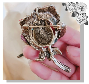 Macro shot of rose brooch back showing vintage alloy texture and secure pin clasp