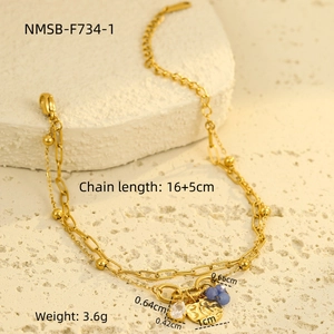 Detail shot of gold titanium bracelet with blue beads, water drop pendant and round charm