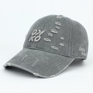Detail of vintage washed grey baseball cap with OKO 3D embroidery and distressed ripped holes