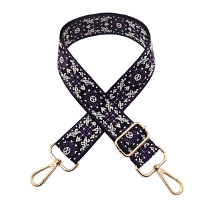 Detail of adjustable purple jacquard shoulder strap with golden metal spring hooks