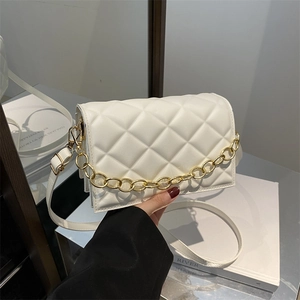Quilted white crossbody bag with gold chain decoration and elegant shoulder strap