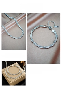 Macro shot of twisted silver rope chain necklace and bracelet jewelry set details