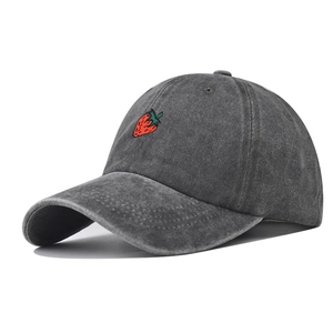 Close-up of strawberry embroidery on washed charcoal grey vintage cotton baseball cap