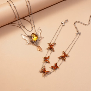 Double-layered butterfly necklace and bracelet set with amber crystals and teardrop pendants
