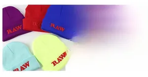 Close-up of RAW letter embroidery on various colorful knit beanies with ribbed texture