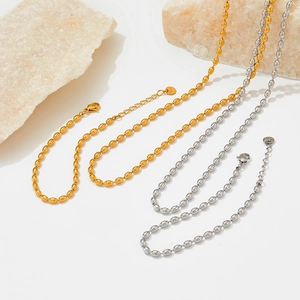 Detail of gold and silver stainless steel oval bead chains with lobster clasp and S.Steel tag