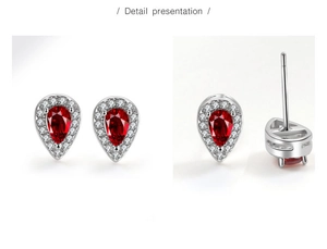 Detail presentation of teardrop red gemstone studs with white zircon halo on silver base