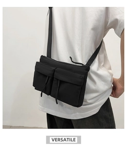Model wearing a black nylon messenger bag with two front pockets and versatile style