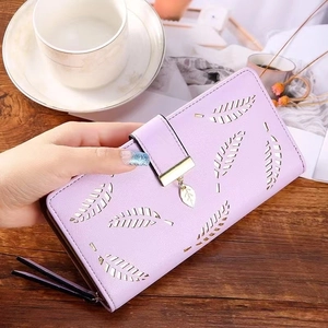 Detailed macro view of lavender faux leather wallet featuring a hollow leaf cutout pattern