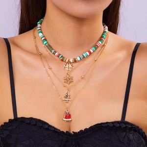 Close-up of three-layered Christmas choker with gold chain, colorful beads and festive charms