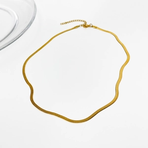 Elegant gold flat snake chain necklace made of stainless steel on minimalist white background