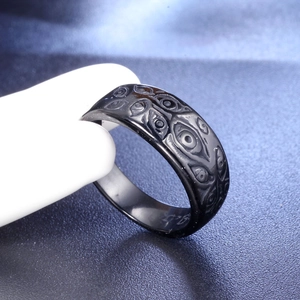 Black stainless steel ring featuring an embossed evil eye pattern for a minimalist style