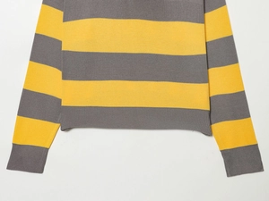 Detail of grey and yellow striped knit fabric with ribbed cuff and high-density texture