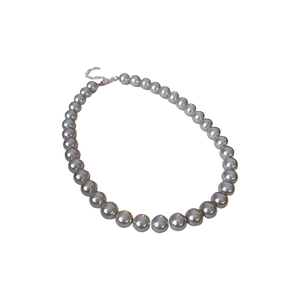 Elegant French vintage grey pearl necklace with a metallic clasp on white background