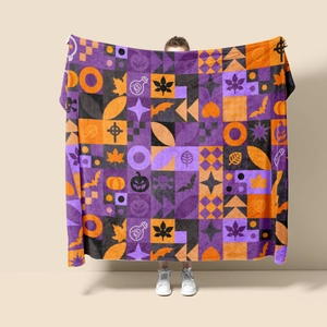 Detail of Halloween flannel blanket featuring purple and orange patchwork with pumpkins