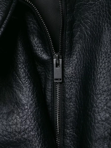 Detail of high-quality lychee texture black leather jacket with matte metal zipper