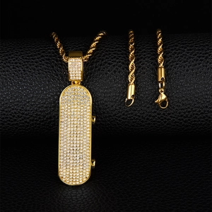 Close-up of golden scooter pendant with crystals on black leather background