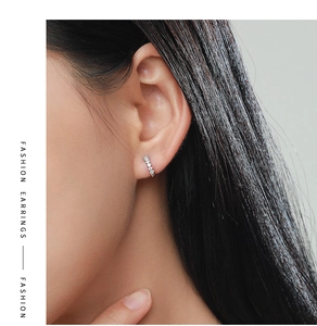 Close-up of S925 sterling silver hoop earrings with micro-inlaid zircon on model's ear
