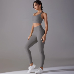 Deep gray two-piece yoga set with cross-back sports bra and high-waisted leggings