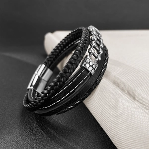 Close-up of men's multi-layer black braided leather bracelet with silver magnetic buckle