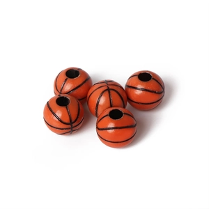 Five orange basketball-shaped acrylic beads with black lines and center holes for jewelry