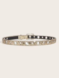 Detailed close-up of a gold sequin belt with silver eyelets and a metallic buckle finish