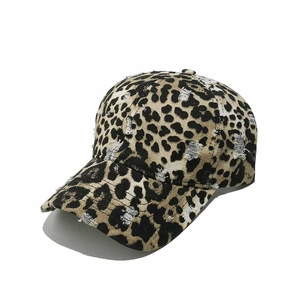 Close-up of leopard print baseball cap with distressed details and vintage street style