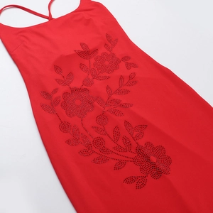 Detailed view of intricate rhinestone floral patterns on a slim red knitted evening dress