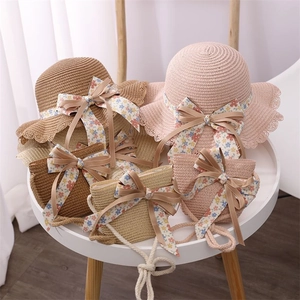 Girl's straw sun hat and matching bag set with floral bows and delicate lace trim