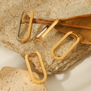 Minimalist 18K gold and silver two-tone oval hoop earrings with polished metal finish