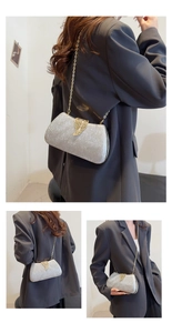 Detail of silver glitter evening clutch with golden leaf clasp and fine chain strap