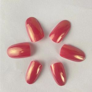 Short oval fake nails in aurora pink with metallic gold sheen and glossy finish
