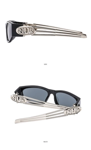 Detail of Y2K sunglasses with silver hollow-out metal temples and NUK logo branding
