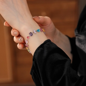 Close-up of a luxury floral bracelet with colorful zircons on a model's wrist